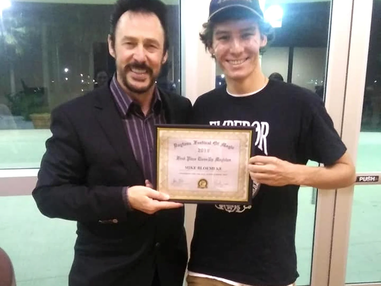 Michael Bloemeke receiving the Daytona Beach Festival of Magic first-place close-up certificate.