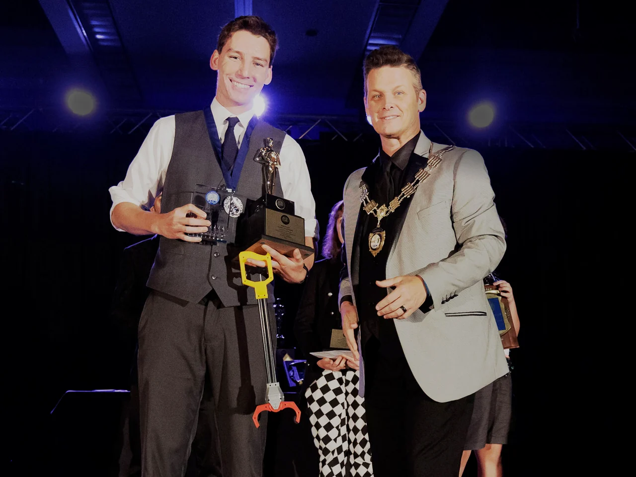 Michael Bloemeke receiving the 2022 IBM Close-Up Champion trophy and medal on stage.