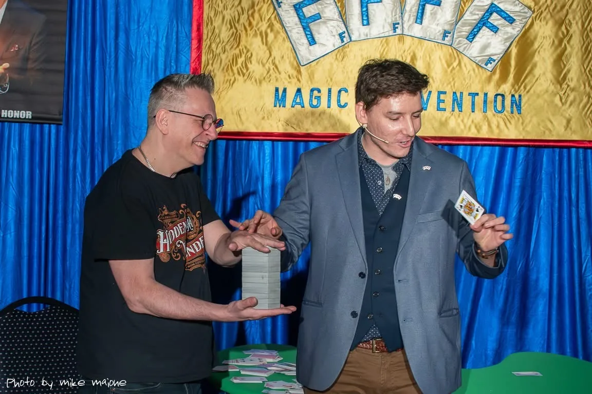 Michael Bloemeke performing a card spread routine at the 4F magic convention.