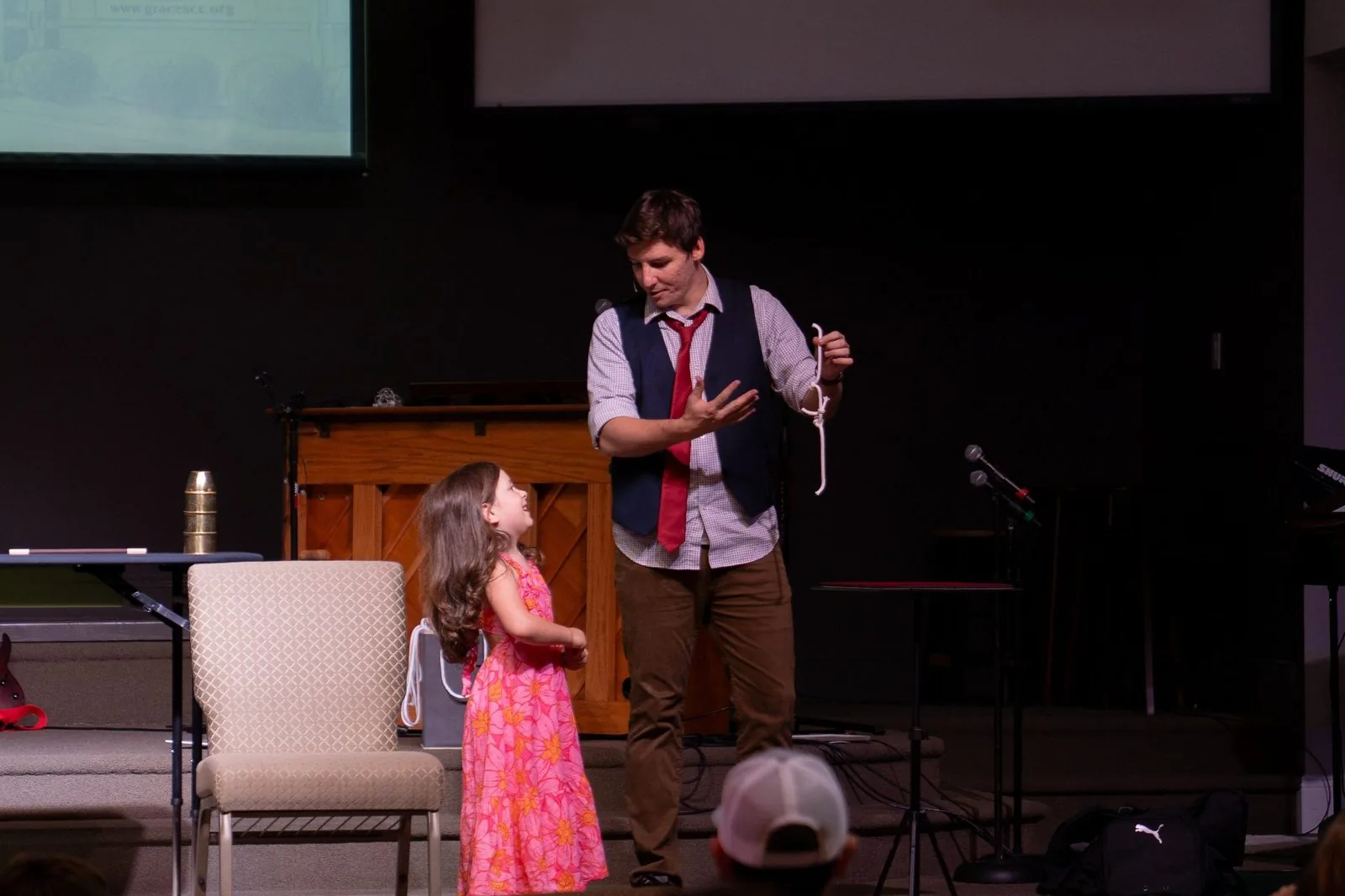 Michael Bloemeke performing a stage routine with a young volunteer.