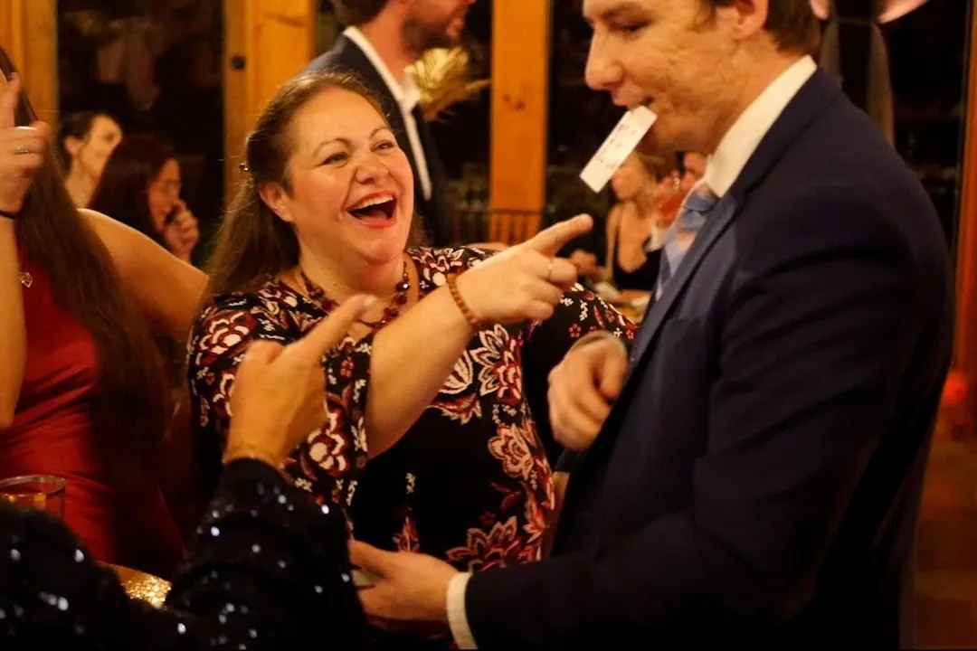 Michael Bloemeke performing magic for a laughing audience